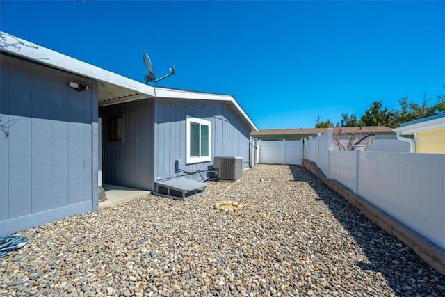 view of side of home featuring central air condition unit and a fenced backyard