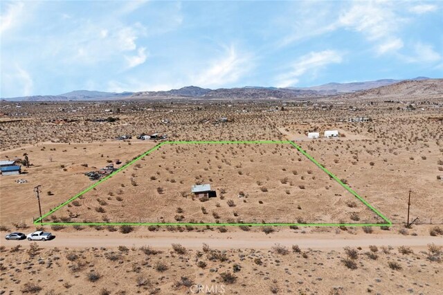 aerial view featuring a mountain view, a rural view, and view of desert