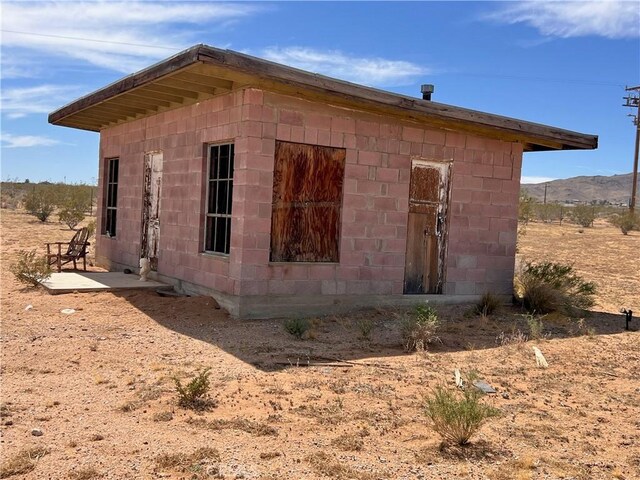 view of property exterior with concrete block siding
