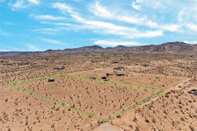 drone / aerial view with a mountain view, a desert view, and a rural view
