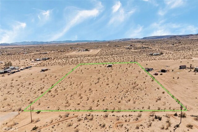 birds eye view of property with a mountain view, a rural view, and view of desert