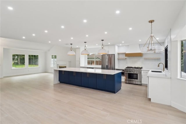 23010 Finch St, Grand Terrace, CA 92313 - kitchen with appliances with stainless steel finishes, custom exhaust hood, open shelves, a spacious island, and light countertops