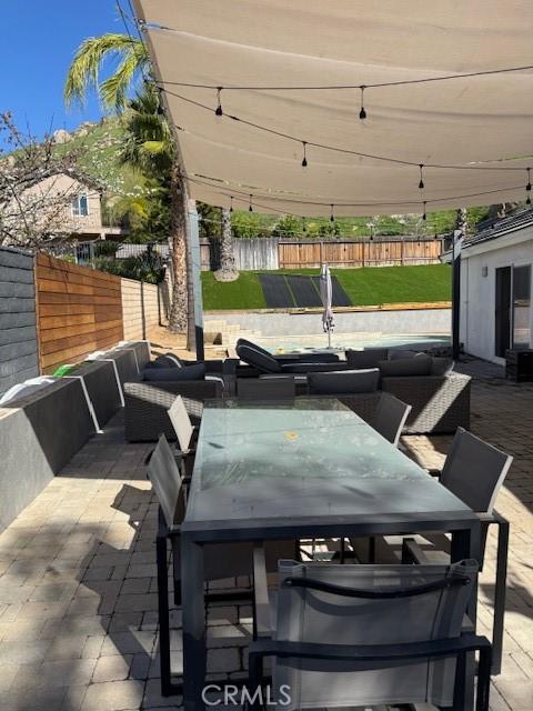 23010 Finch St, Grand Terrace, CA 92313 - fenced backyard with outdoor dining space, a patio, and outdoor lounge area