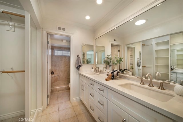 33571 Binnacle Dr, Dana Point, CA 92629 - bathroom with double vanity, tiled shower, a spacious closet, tile patterned flooring, and ornamental molding
