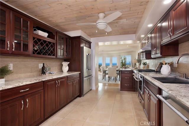 33571 Binnacle Dr, Dana Point, CA 92629 - kitchen with high end appliances, wood ceiling, light tile patterned floors, decorative backsplash, and a ceiling fan