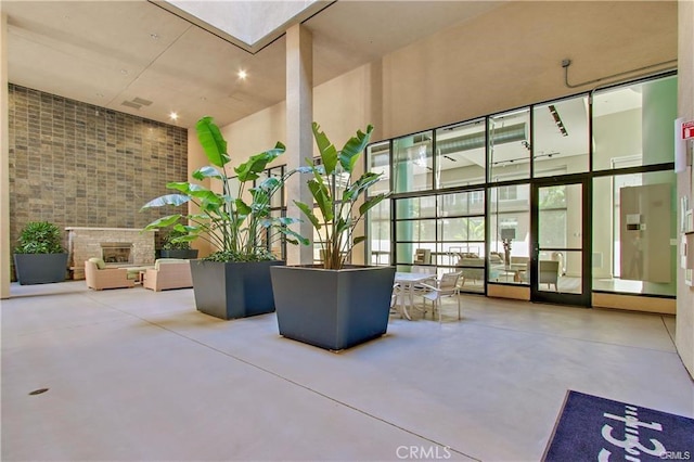 133 The Promenade N Unit 317, Long Beach, CA 90802 - community lobby featuring brick wall and a towering ceiling