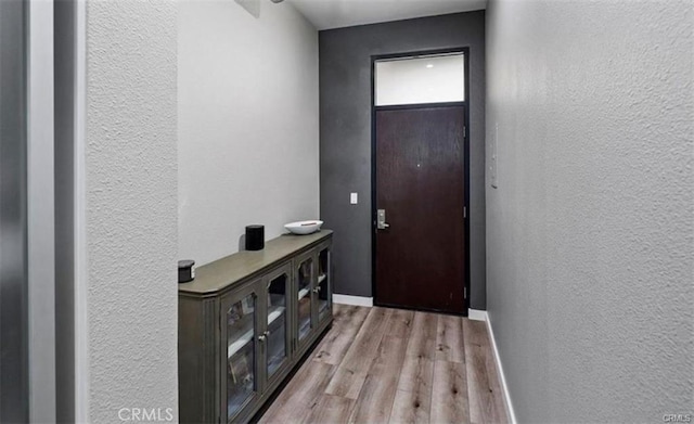 133 The Promenade N Unit 317, Long Beach, CA 90802 - entryway featuring a textured wall, light wood-style flooring, and baseboards