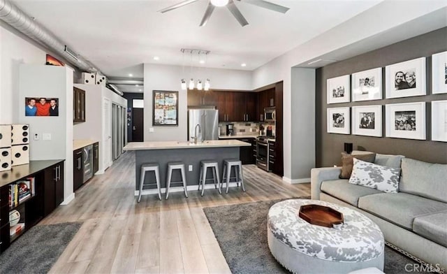 133 The Promenade N Unit 317, Long Beach, CA 90802 - living room with ceiling fan, light wood-style floors, recessed lighting, and baseboards