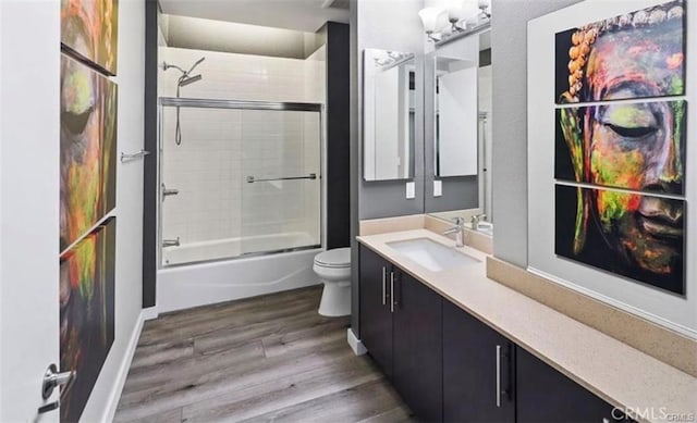133 The Promenade N Unit 317, Long Beach, CA 90802 - bathroom with vanity, wood finished floors, toilet, bath / shower combo with glass door, and baseboards