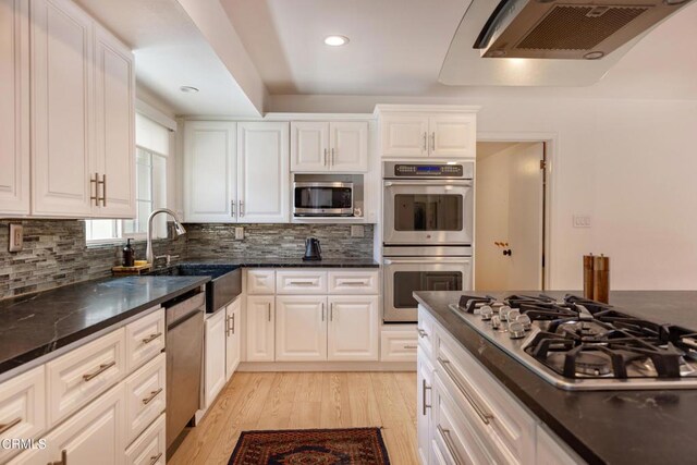1009 Grandview Ave, Ojai, CA 93023 - kitchen with appliances with stainless steel finishes, light wood finished floors, decorative backsplash, white cabinetry, and recessed lighting