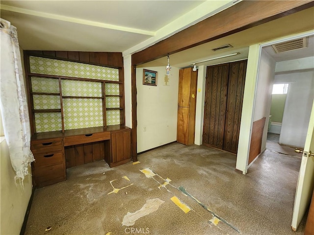 interior space featuring wood walls and visible vents