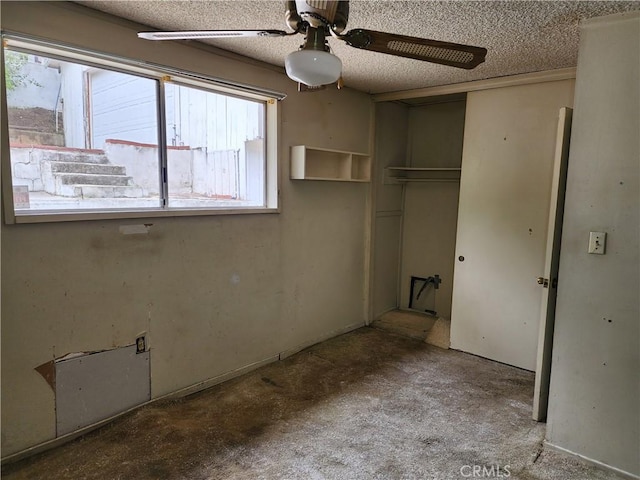 unfurnished bedroom featuring a closet, multiple windows, and a ceiling fan