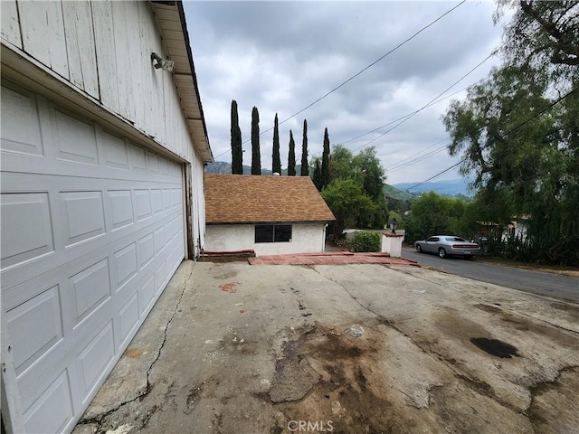 exterior space featuring a garage and aphalt driveway