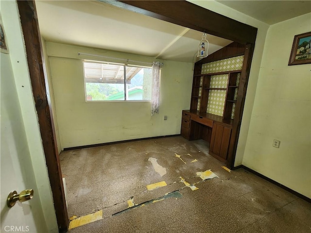 spare room featuring baseboards