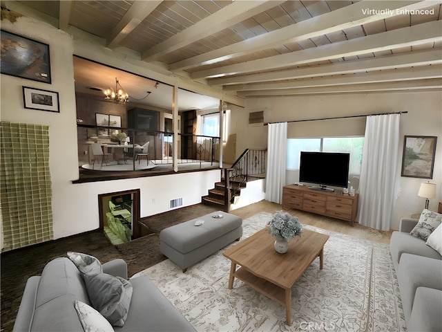 carpeted living area with visible vents, stairway, beam ceiling, and a notable chandelier