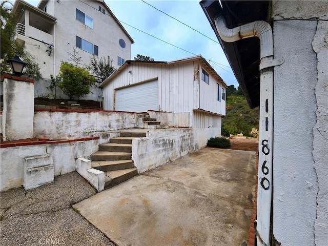view of home's exterior featuring a garage and an outdoor structure