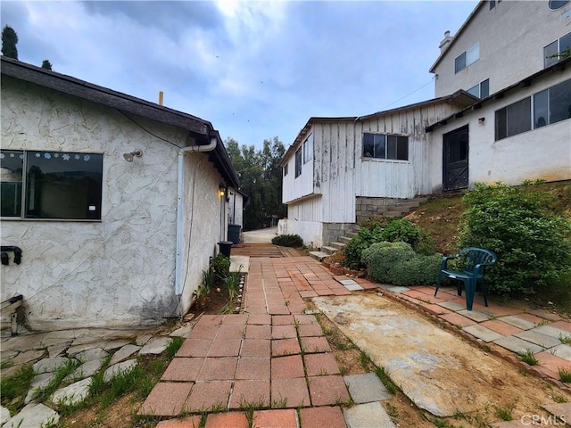 view of home's exterior featuring a patio and entry steps