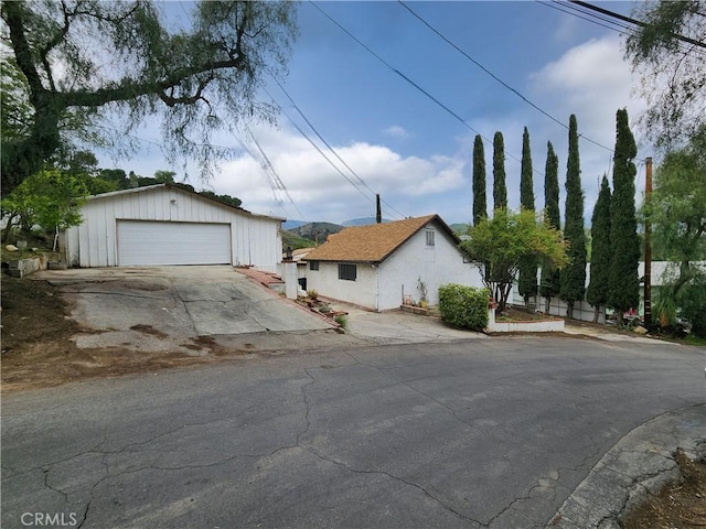 view of front of house featuring an outbuilding and a detached garage