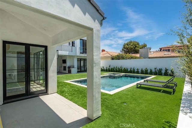 view of swimming pool featuring a lawn, a fenced backyard, french doors, and a patio