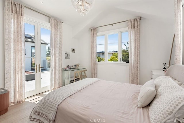 bedroom featuring lofted ceiling, access to exterior, multiple windows, and french doors