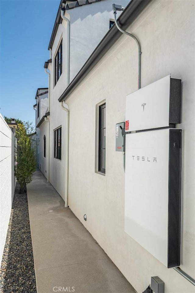 view of property exterior featuring fence and stucco siding
