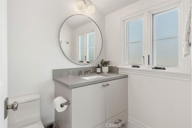 bathroom with toilet and vanity