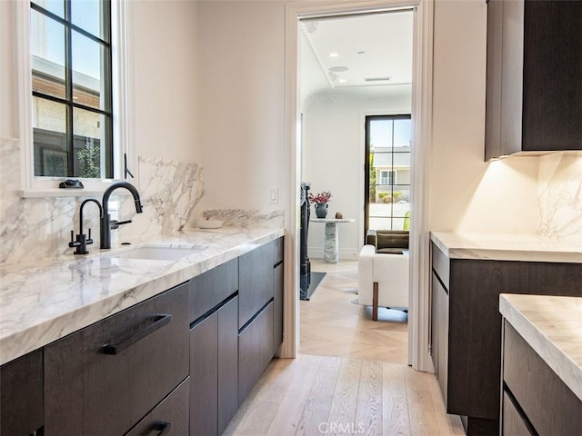 bathroom with backsplash, wood finished floors, and vanity