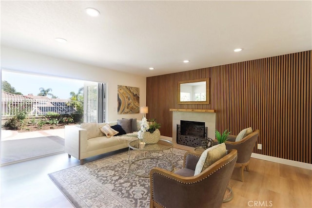 living area featuring a fireplace, recessed lighting, and wood finished floors