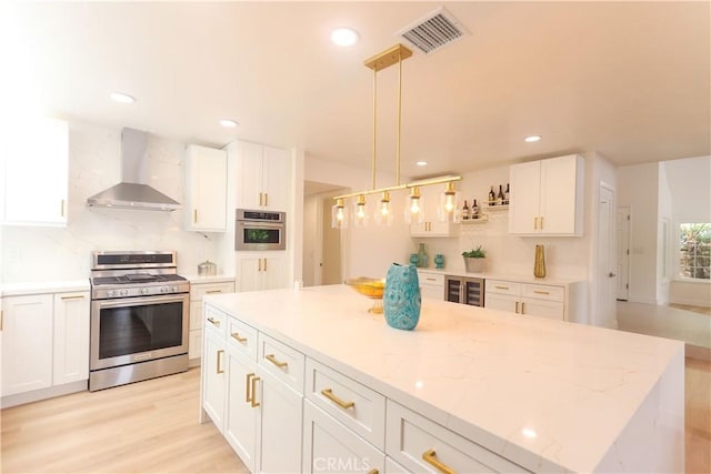 26306 Ganiza, Mission Viejo, CA 92692 - kitchen featuring appliances with stainless steel finishes, wall chimney range hood, white cabinetry, and recessed lighting