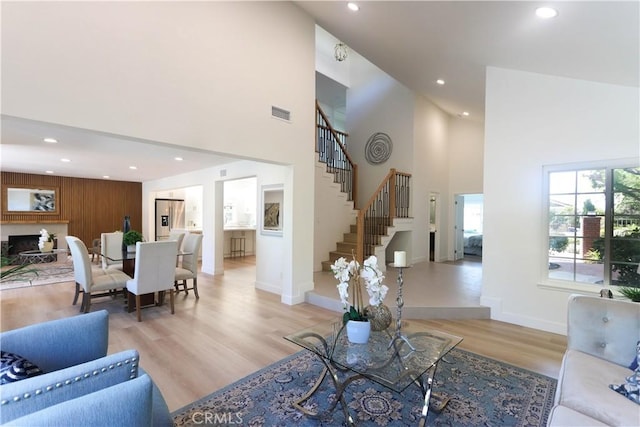 living area featuring recessed lighting, stairway, and a towering ceiling