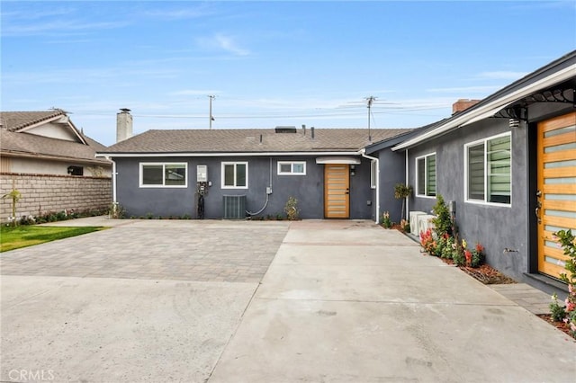 5591 Heil Ave, Huntington Beach, CA 92649 - single story home with stucco siding, cooling unit, fence, and a chimney