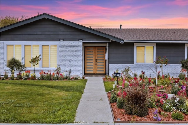 5591 Heil Ave, Huntington Beach, CA 92649 - view of front of property with brick siding, a yard, and roof with shingles