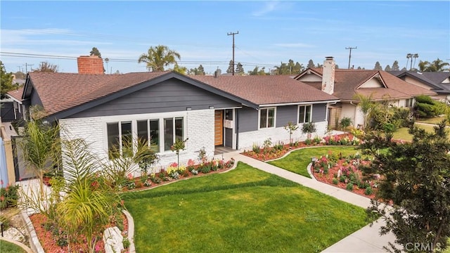 5591 Heil Ave, Huntington Beach, CA 92649 - single story home featuring a chimney, a front yard, brick siding, and a shingled roof