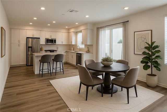 1940 N Bloom Dr, Compton, CA 90222 - dining room with wood finished floors, baseboards, and recessed lighting