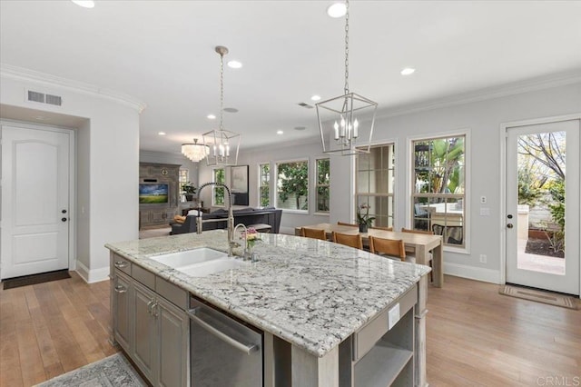 kitchen with a notable chandelier, baseboards, visible vents, stainless steel dishwasher, and a sink