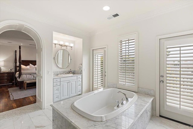 ensuite bathroom with vanity, ensuite bath, crown molding, a bath, and visible vents
