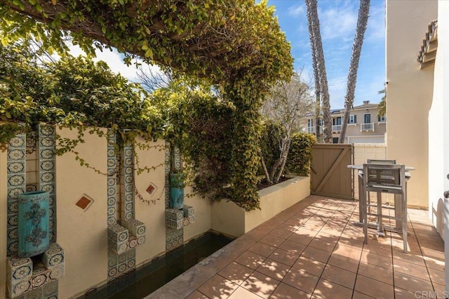 view of patio with fence and a gate