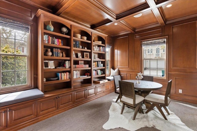 dining space featuring coffered ceiling, ornamental molding, wooden ceiling, and carpet