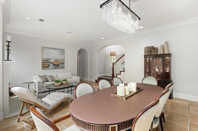 dining area with recessed lighting, arched walkways, ornamental molding, and stairs