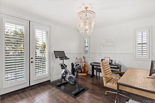 office area featuring a notable chandelier, ornamental molding, a wainscoted wall, and wood finished floors