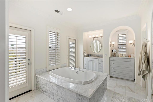 bathroom with visible vents, marble finish floor, a garden tub, vanity, and ornamental molding