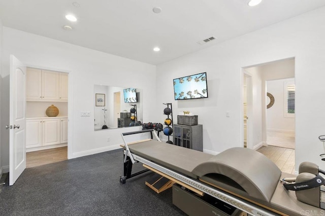 workout area featuring baseboards, visible vents, and recessed lighting