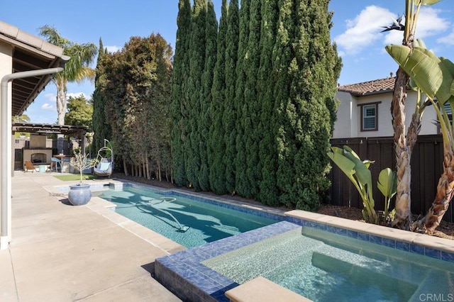 view of pool featuring fence, a patio area, a fenced in pool, and an in ground hot tub
