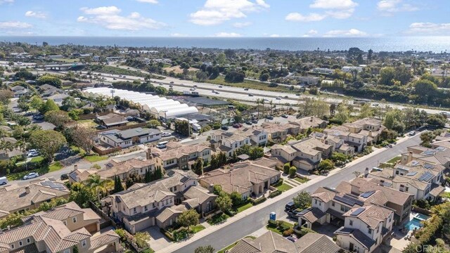 bird's eye view with a residential view and a water view