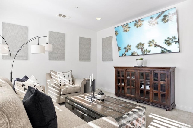 carpeted living room featuring recessed lighting, visible vents, and baseboards