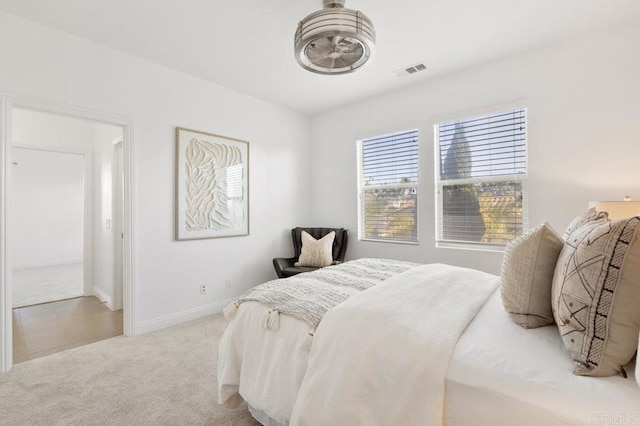bedroom featuring baseboards, carpet flooring, and visible vents