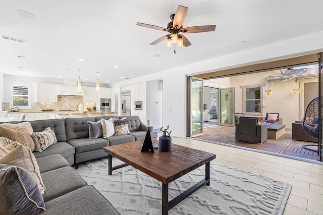 living room with ceiling fan, light tile patterned flooring, visible vents, and recessed lighting