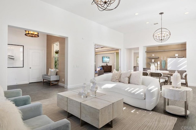 living room with recessed lighting, an inviting chandelier, wood finished floors, and baseboards