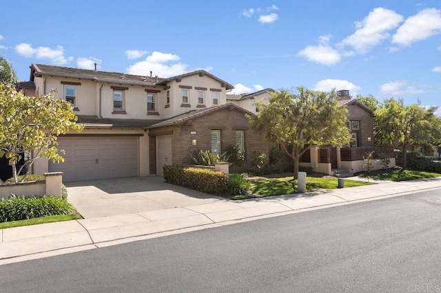 traditional home featuring a garage, driveway, a tiled roof, and stucco siding