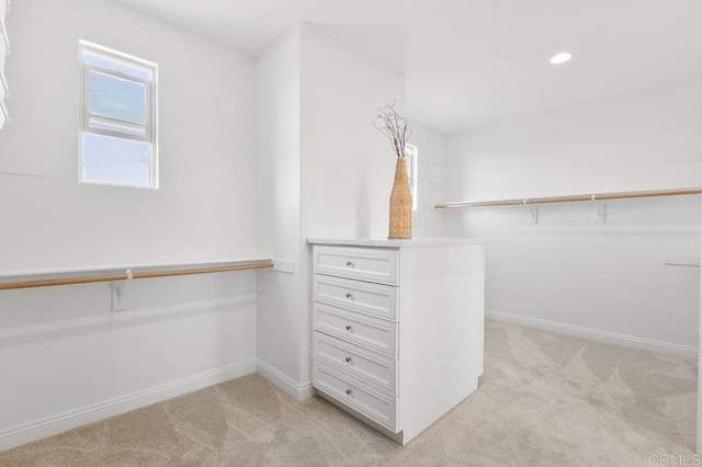 spacious closet with light colored carpet